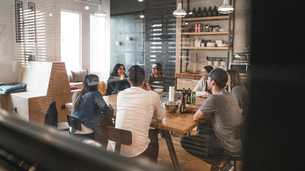Group of sales leaders sitting around in a modern office meeting room