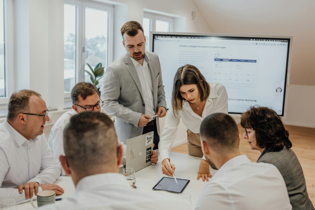 A high-performing sales team gathered around a table discussing data